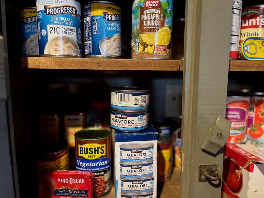canned goods including tuna in pantry