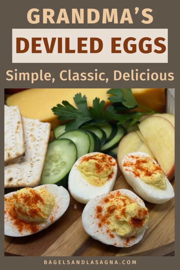 Grandma's deviled eggs garnished with paprika are surrounded by cucumber slices, apple wedges, fresh parsley, cheese, and crackers. Text reads: "Simple, Classic, Delicious.