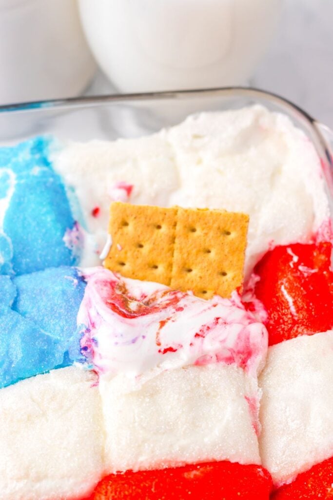 Rectangular dish with colorful block gelatins in red, white, and blue, topped with a single graham cracker.