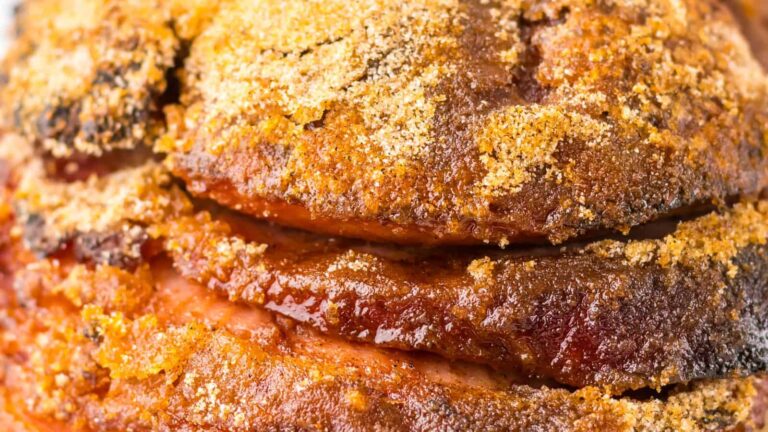 Close-up of seasoned and roasted meat with crispy edges.