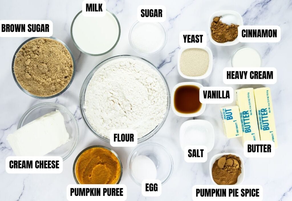 Labeled ingredients for baking, including flour, pumpkin puree, cream cheese, sugar, brown sugar, egg, milk, yeast, butter, heavy cream, vanilla, salt, cinnamon, and pumpkin pie spice.