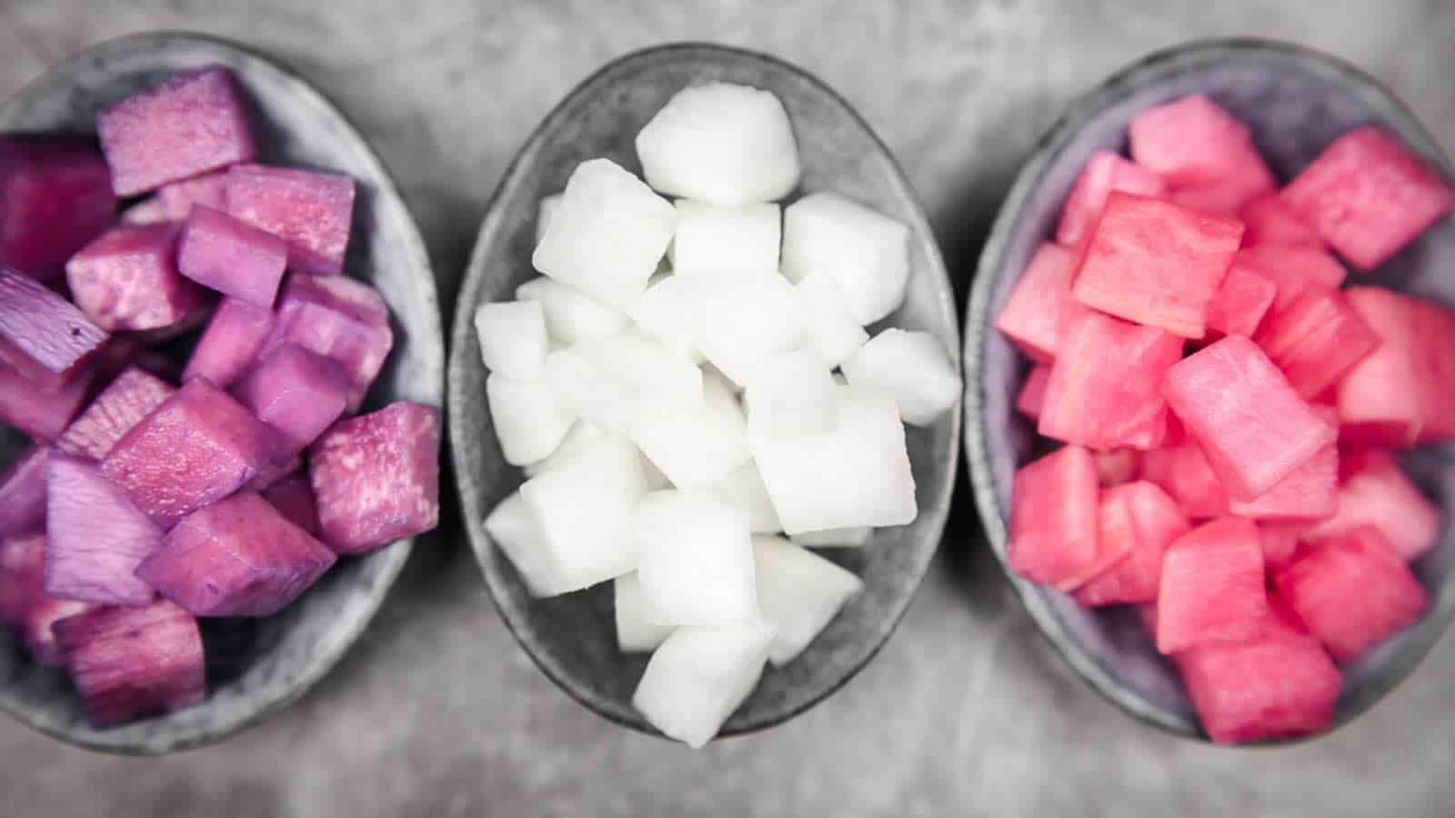 Three bowls with diced pickled daikon.