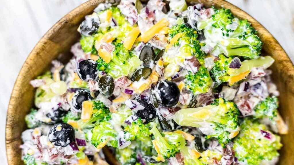 Broccoli Salad with Bacon inside wooden bowl.