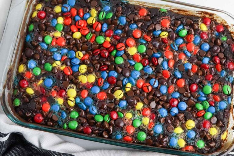 Chocolate dump cake topped with colorful M&Ms.