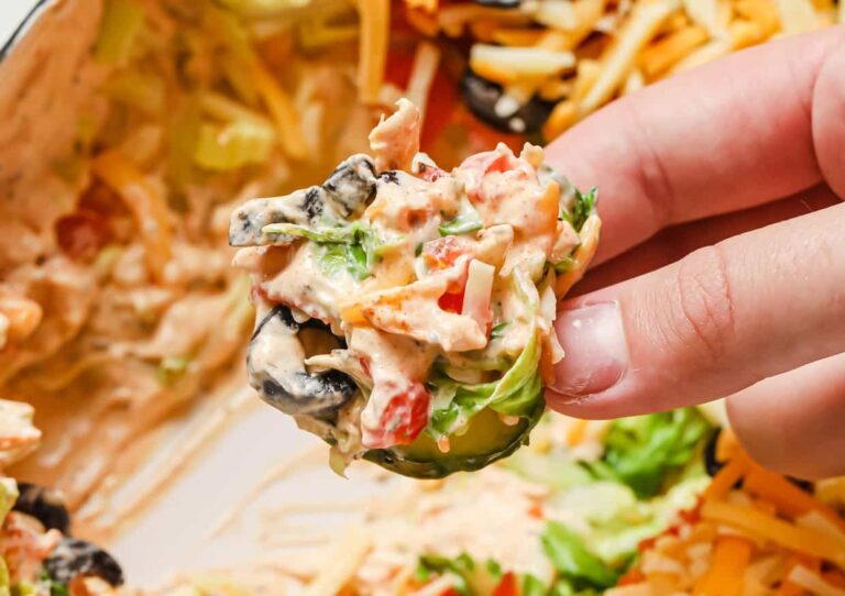A person holding a salad.