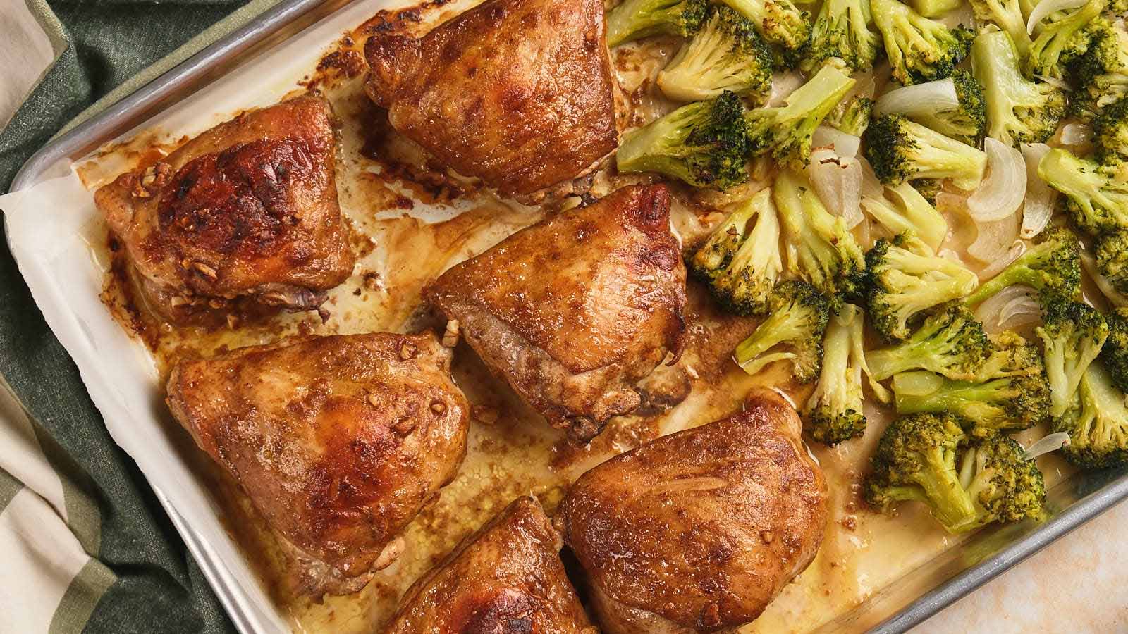 Sheet pan chicken thighs and roasted broccoli with onions.
