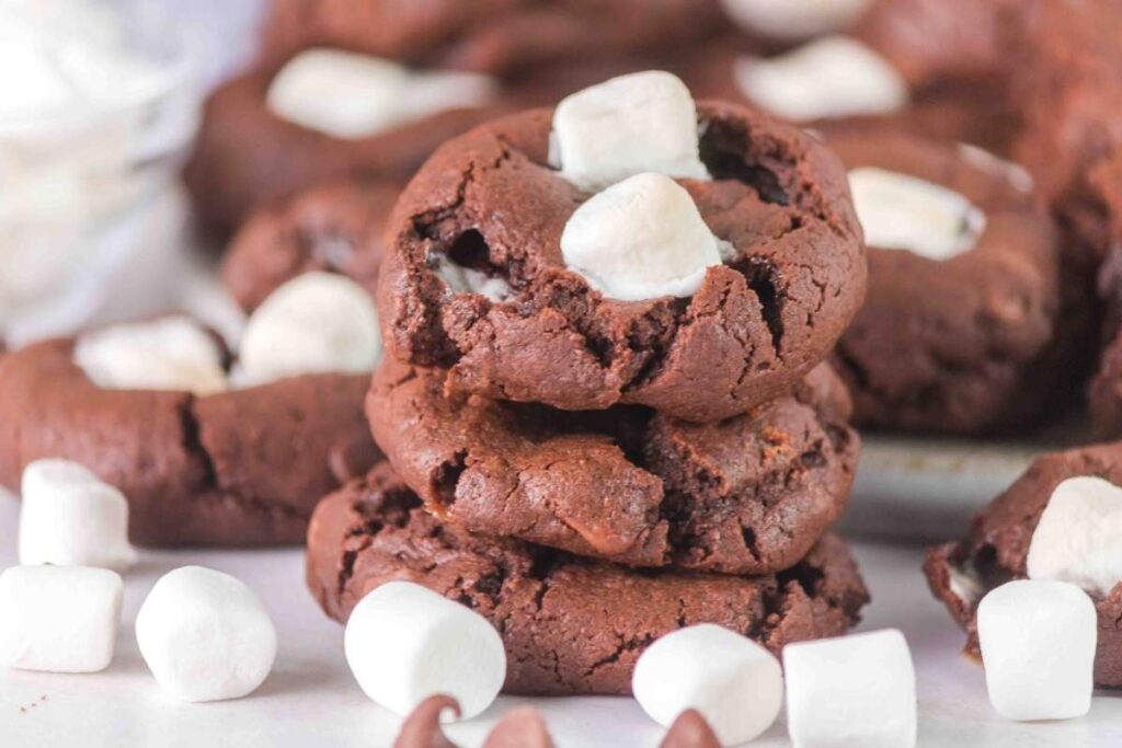 A stack of chocolate cookies with marshmallows.