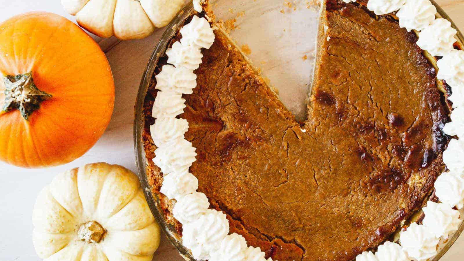Overhead view of pumpkin pie with a slice missing.