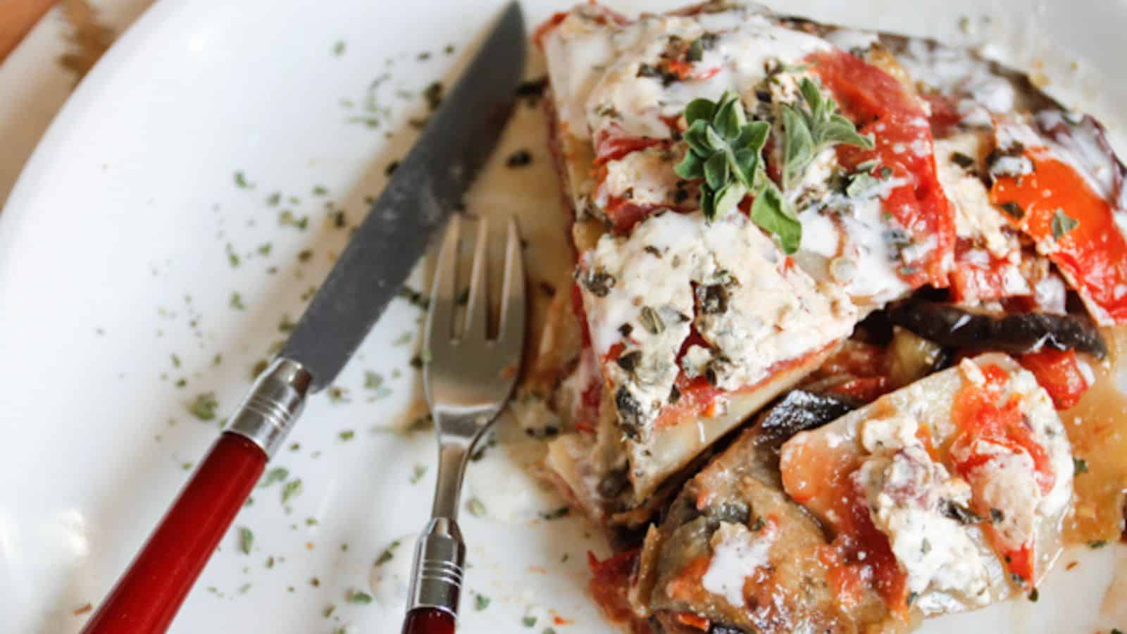 Slice of Cold Moussaka With Kalamata Feta Sauce.