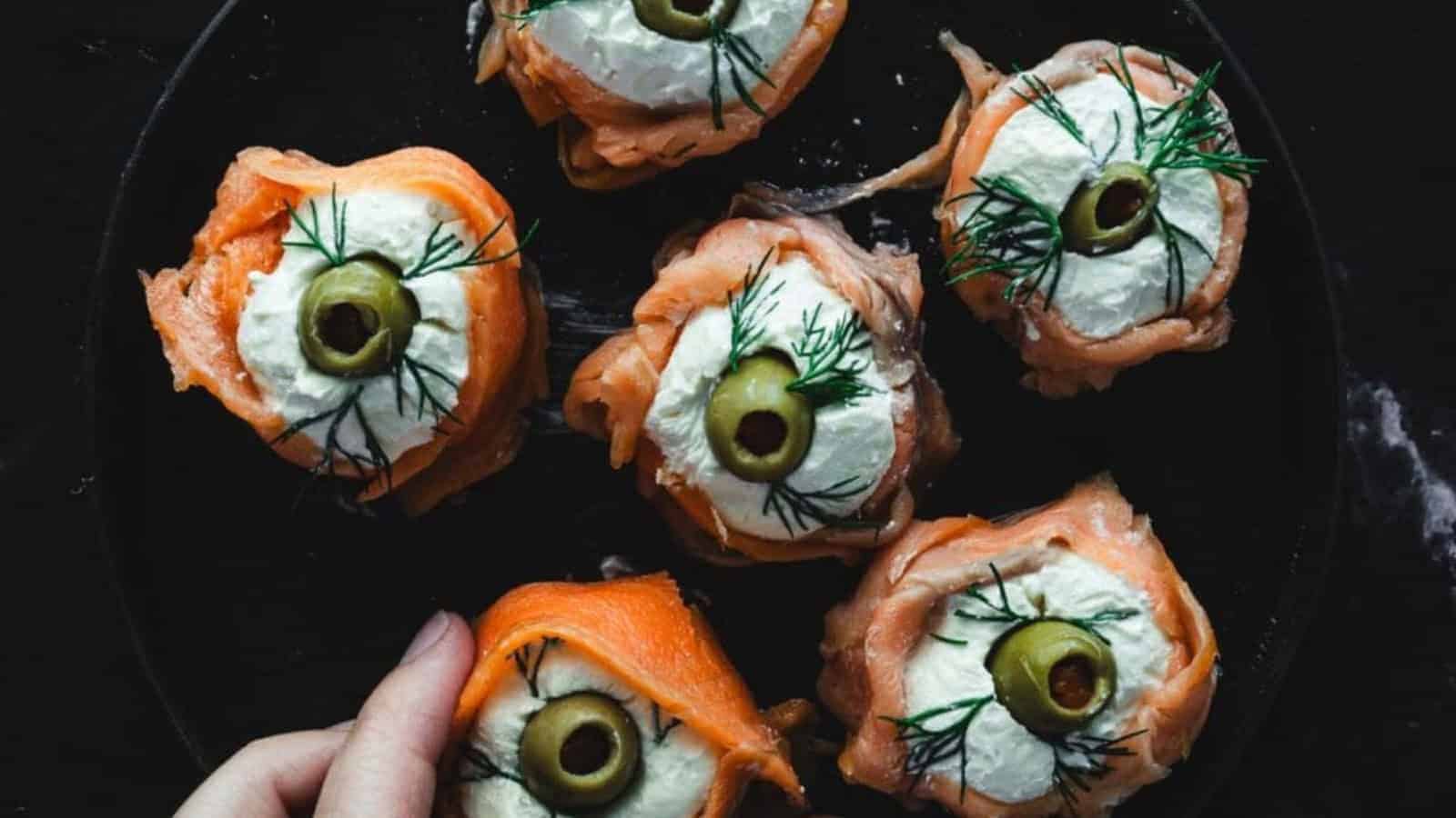 hand holding one Easy Smoked Salmon Canapes.
