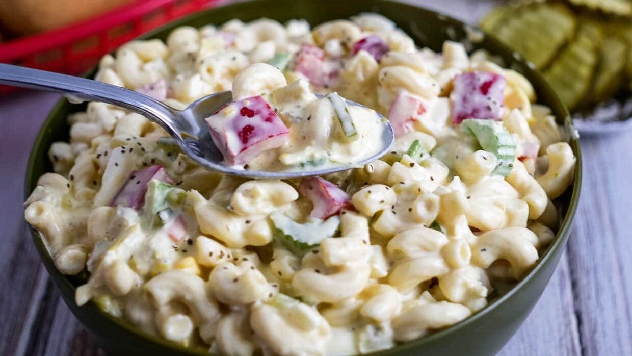 Bowl of Amish macaroni salad with some on a spoon.