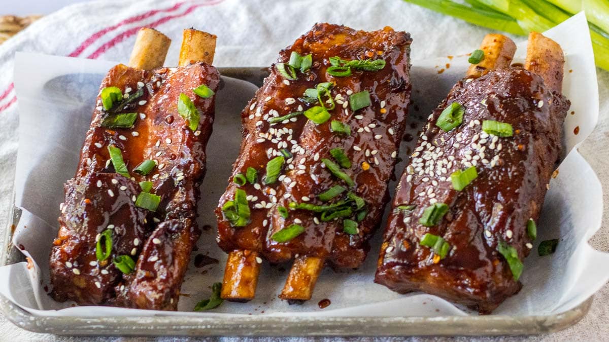 Two ribs on a tray with sesame seeds and sesame seeds.