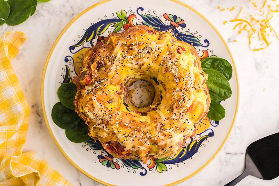 Loaded bagel breakfast bake casserole with eggs, cheese, and bagel pieces.