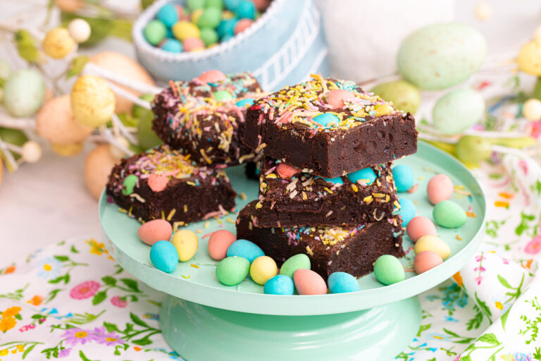 Easter brownies topped with pastel candy eggs and festive decorations.