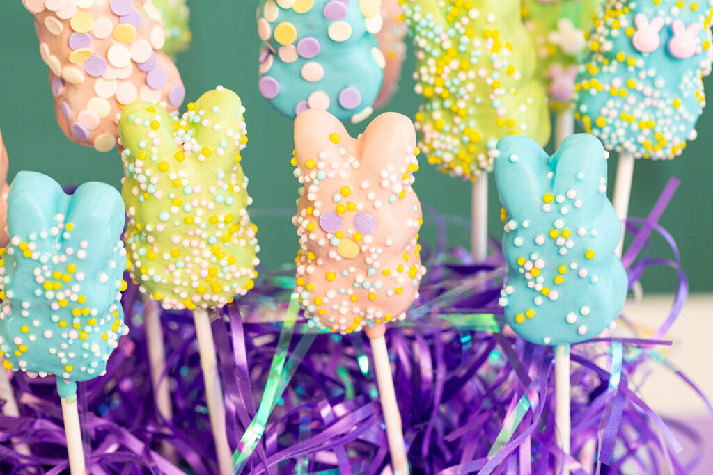 Chocolate-covered marshmallow Peeps decorated with colorful Easter sprinkles.