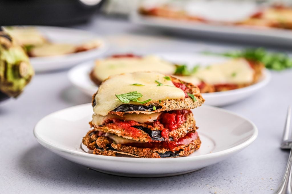 Crispy Air Fryer Eggplant Parmesan on a white plate.