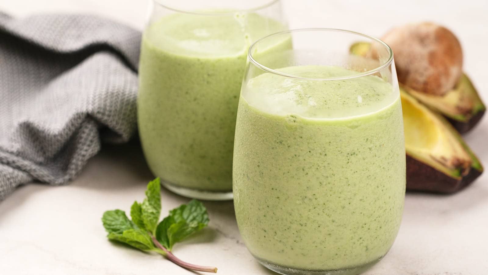 Dairy-free Keto Green Smoothie in two glasses with ingredients around.