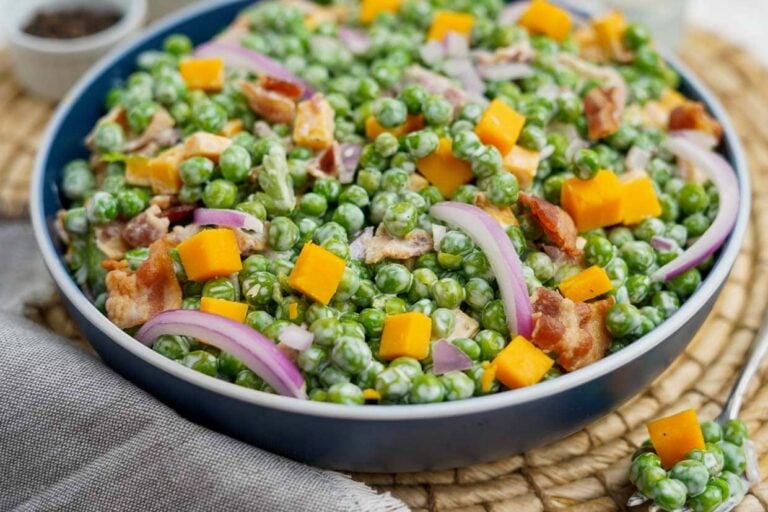 Pea salad in a blue bowl.