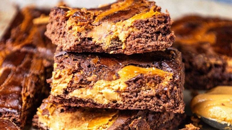Deliciously swirled brownie bars with a rich chocolate layer and peanut butter filling, stacked on top of each other.