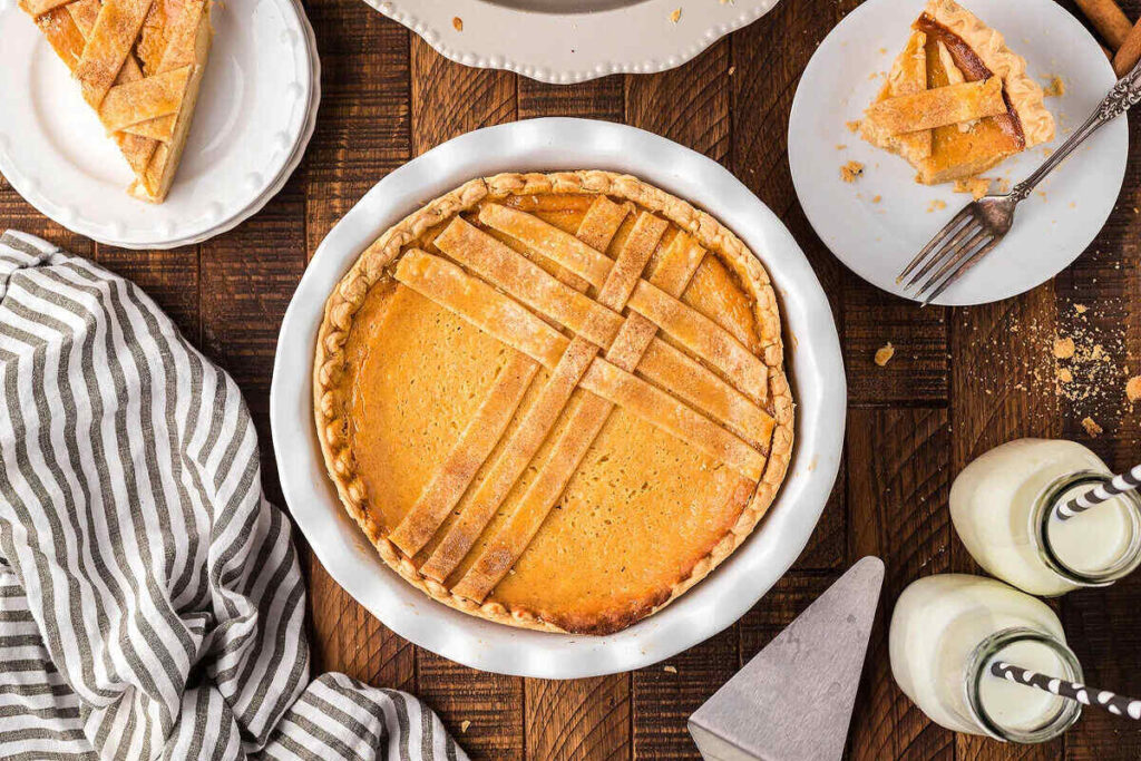A slice of Sweet Italian ricotta pie on a wooden table.